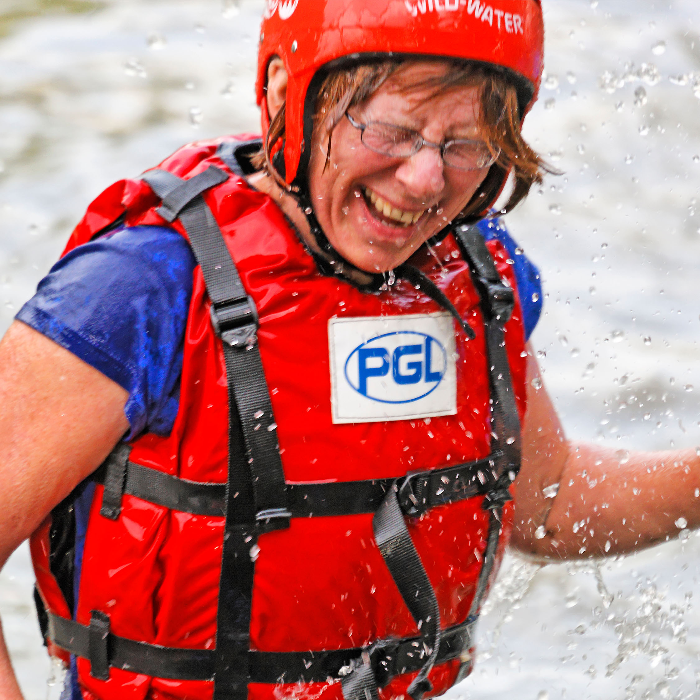 Teacher enjoying the water during raft building at PGL